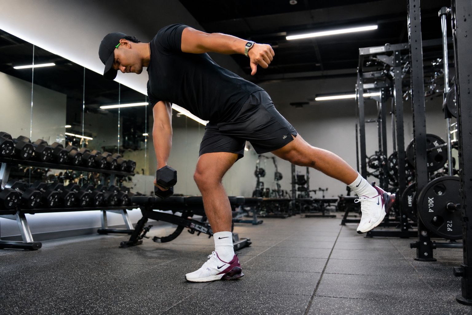 Lashawn demonstrating a single-leg dumbbell exercise during a strength training session